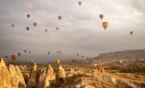 Montgolfières survolant les cheminées de fées de la Cappadoce au lever du soleil