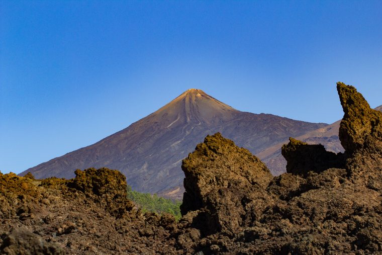 Paysage volcanique aride contrastant avec l'océan aux îles Canaries
